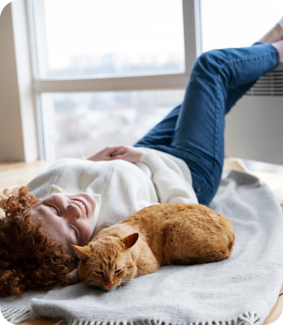 full shot woman cat laying blanket